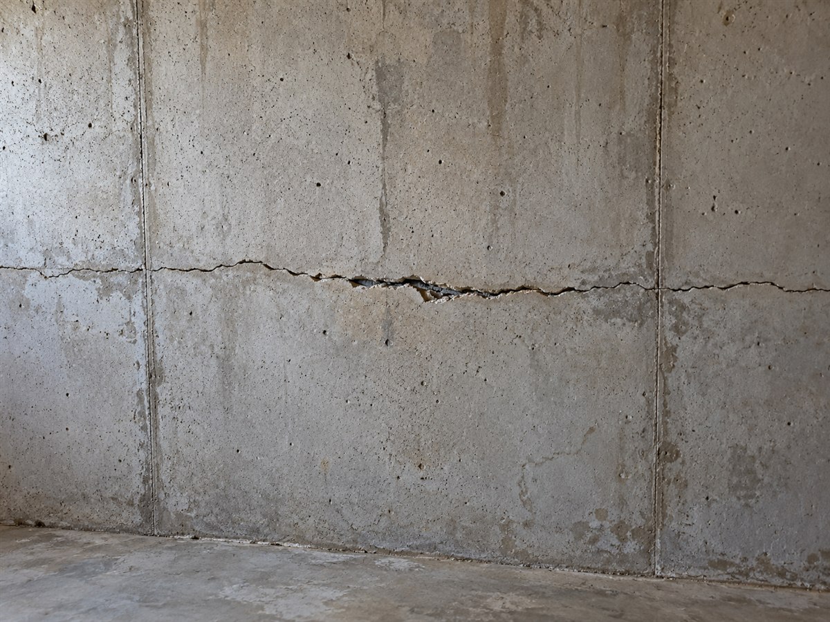Horizontal crack running across a poured concrete basement wall